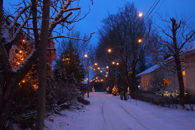 Luminen kuja, jonka varrella taloja ja erilaisia valoja.